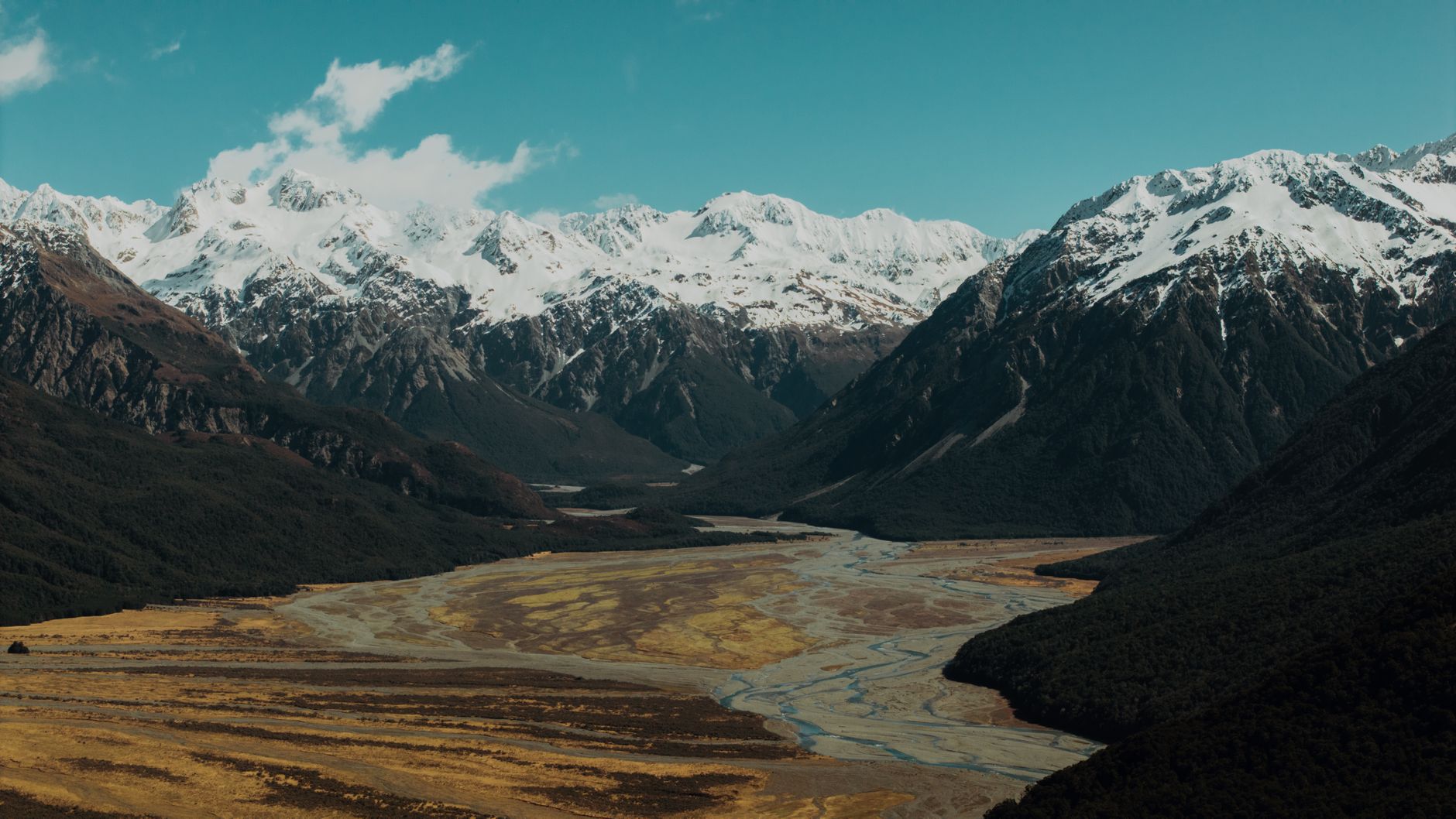 Majestic mountain peaks in New Zealand Southern Alps with emerald river valley