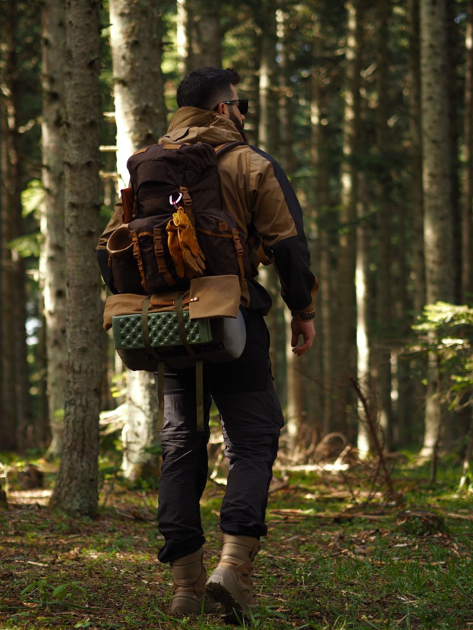 Hiker preparing tramping gear and boots for multi-day trek