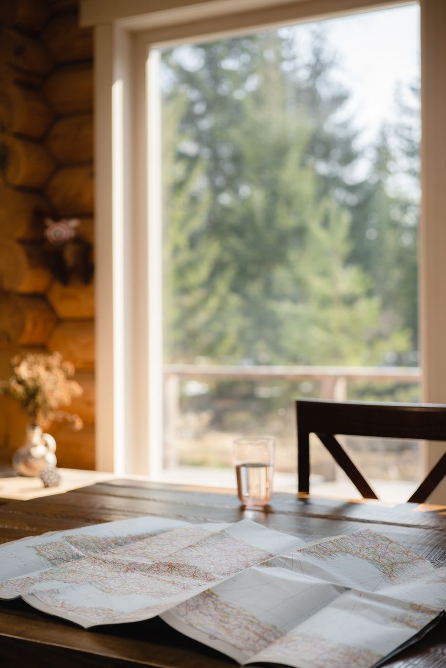 Traveller consulting with map in modern scenic lodge
